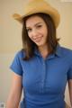 A woman in a blue shirt and a straw hat.