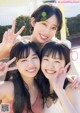 A group of three young women posing for a picture.