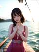 A woman in a pink dress standing on a dock.